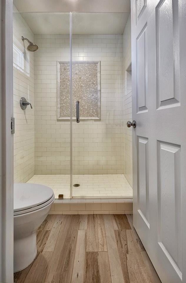 Mid-sized modern bathroom in Sacramento with a drop-in sink, a corner shower, a one-piece toilet, beige tile, subway tile and light hardwood floors.