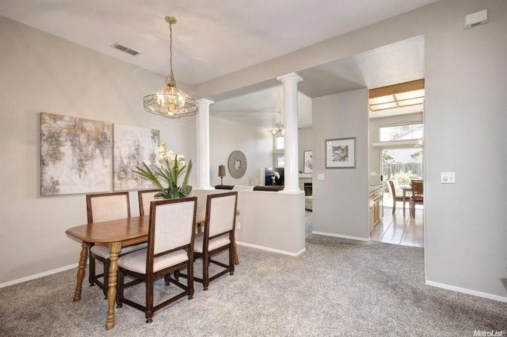 Inspiration for a mid-sized transitional separate dining room in Sacramento with grey walls, carpet and no fireplace.