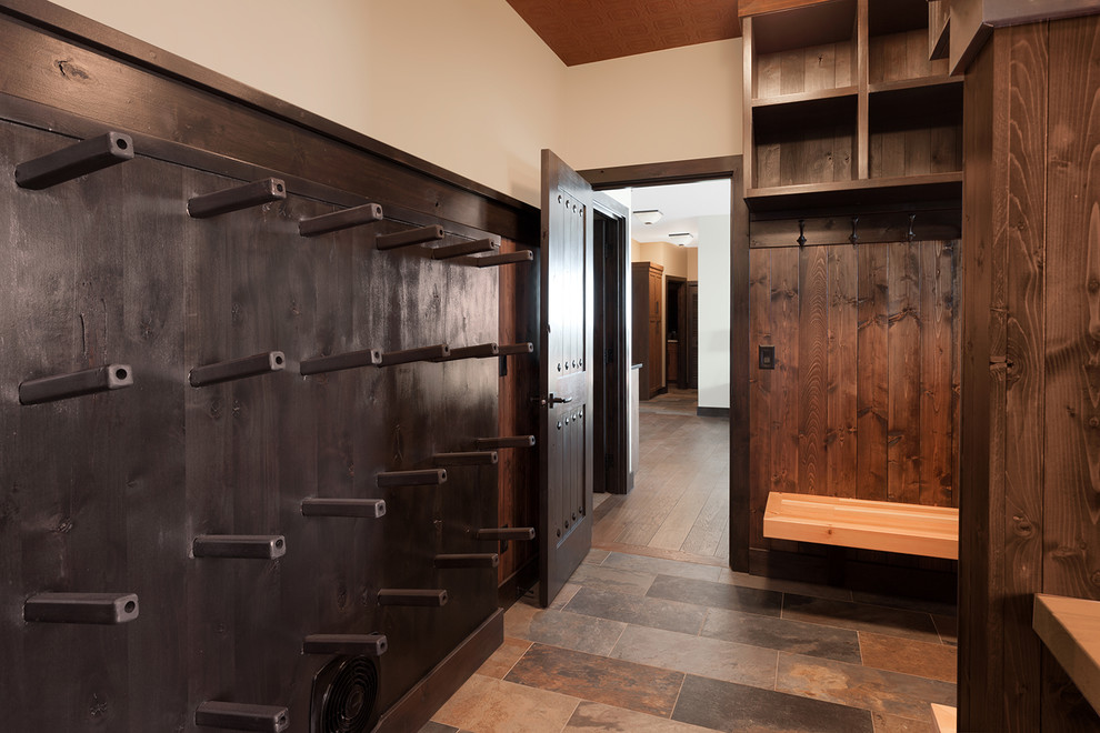 Inspiration for a rustic slate floor and multicolored floor mudroom remodel with beige walls