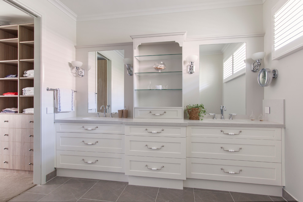 Inspiration for a mid-sized transitional master bathroom in Melbourne with a drop-in sink, flat-panel cabinets, white cabinets, marble benchtops, gray tile, ceramic tile, white walls and ceramic floors.