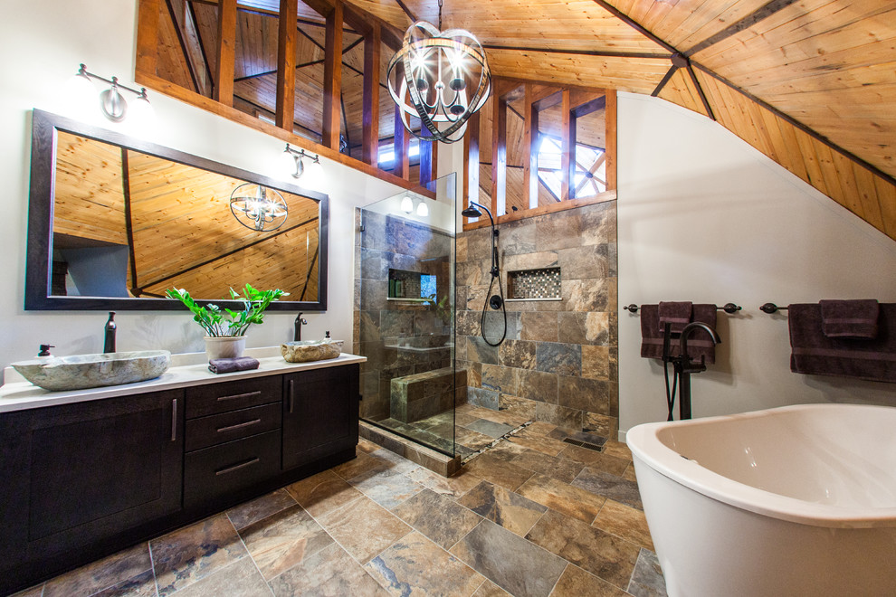 Inspiration for a mid-sized rustic master multicolored tile and porcelain tile porcelain tile and multicolored floor freestanding bathtub remodel with a vessel sink, shaker cabinets, quartz countertops, a one-piece toilet, gray walls and dark wood cabinets