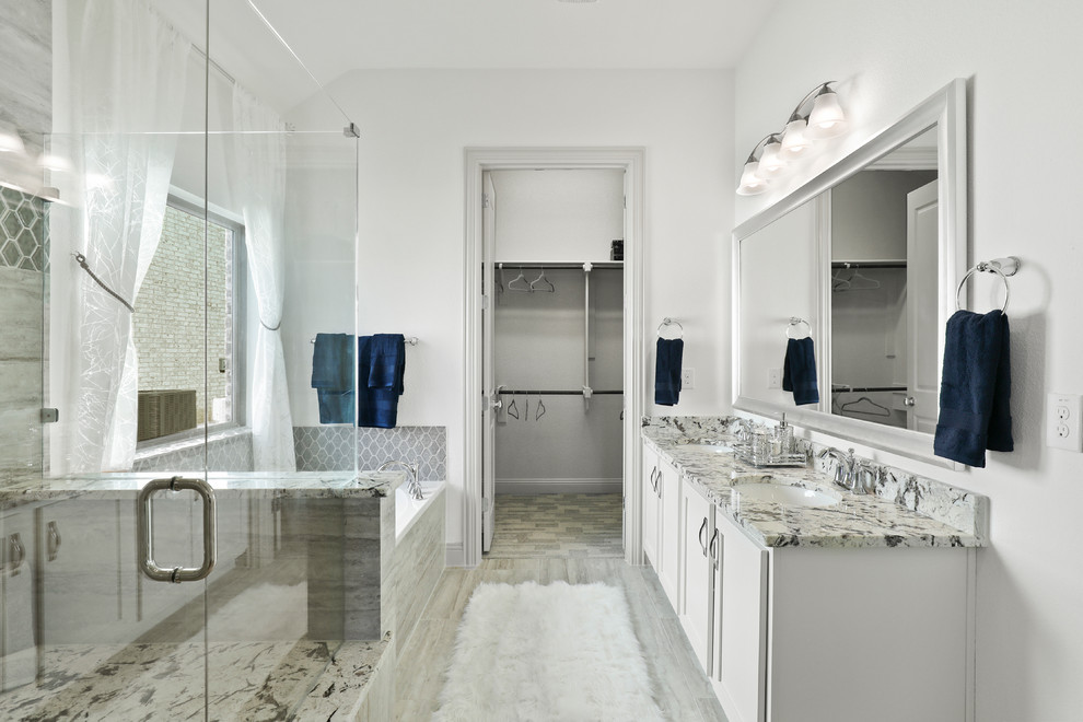 Design ideas for a mid-sized traditional master bathroom in Dallas with shaker cabinets, grey cabinets, an undermount tub, a corner shower, beige tile, ceramic tile, white walls, ceramic floors, an undermount sink, granite benchtops, a hinged shower door, multi-coloured benchtops and beige floor.
