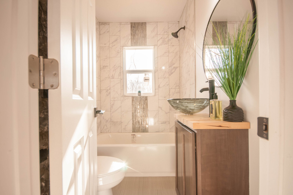 This is an example of a small modern bathroom in Grand Rapids with white tile, ceramic tile, a vessel sink and wood benchtops.