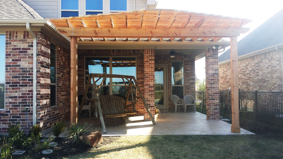 Inspiration for a small backyard concrete patio remodel in Houston with a pergola