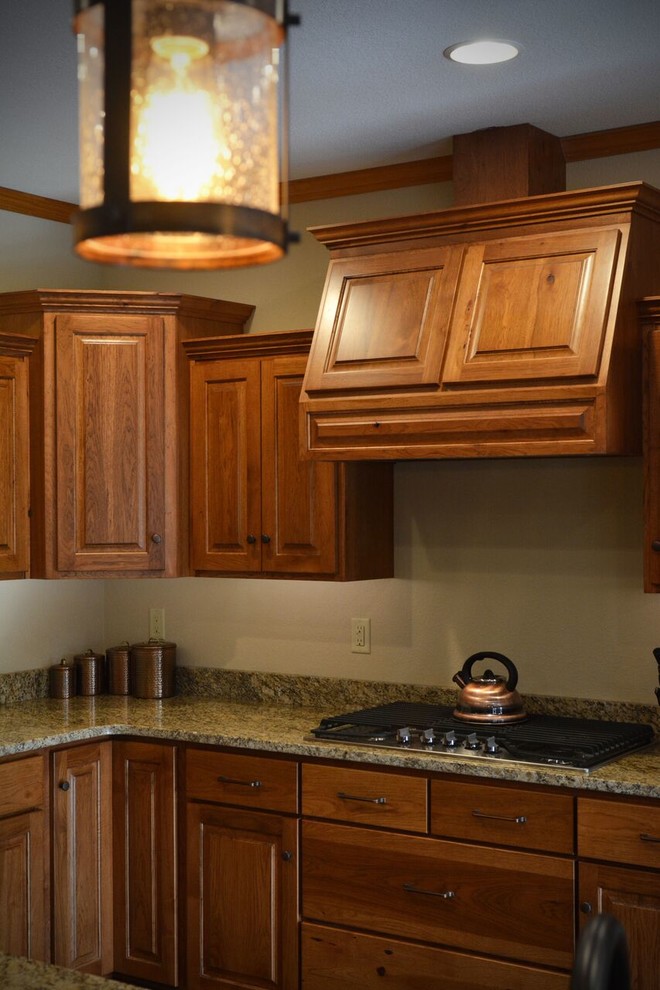 Inspiration for a large transitional l-shaped medium tone wood floor kitchen remodel with a farmhouse sink, raised-panel cabinets, light wood cabinets, granite countertops, stainless steel appliances and an island
