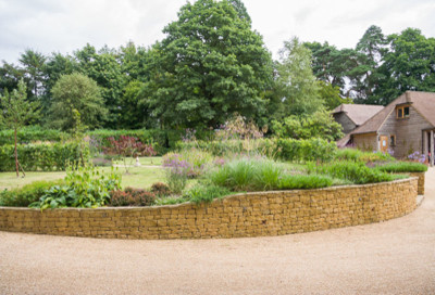 Inspiration for a modern front driveway full sun garden in Surrey with gravel.
