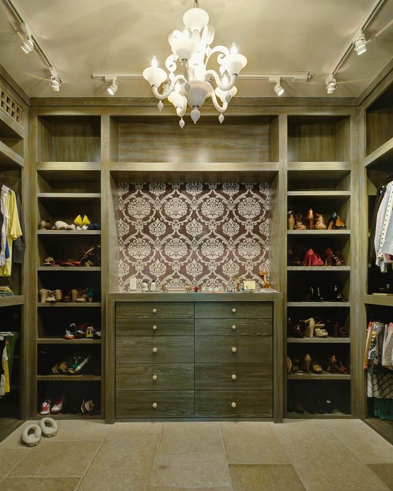 Design ideas for a mid-sized contemporary women's walk-in wardrobe in Houston with flat-panel cabinets, distressed cabinets and limestone floors.