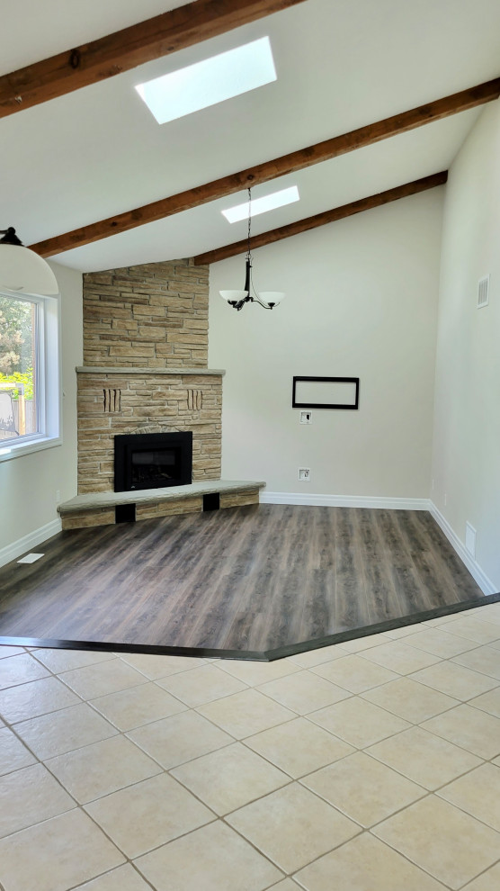 Open concept kitchen - transitional u-shaped open concept kitchen idea with an undermount sink, recessed-panel cabinets, white cabinets, multicolored backsplash, stone tile backsplash, stainless steel appliances and a peninsula