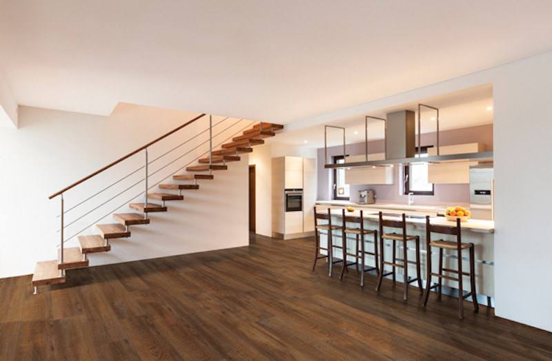 Example of a mid-sized minimalist galley dark wood floor and brown floor open concept kitchen design in Phoenix with an undermount sink, flat-panel cabinets, white cabinets, stainless steel appliances and a peninsula