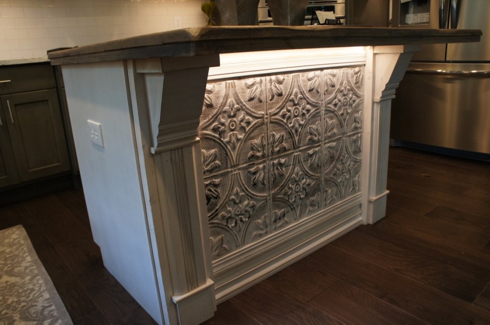 Inspiration for a transitional u-shaped eat-in kitchen remodel with flat-panel cabinets, white backsplash, stainless steel appliances and an island