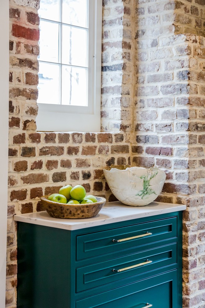 Kitchen pantry - mid-sized transitional medium tone wood floor and brown floor kitchen pantry idea in Charleston with a farmhouse sink, beaded inset cabinets, green cabinets, quartz countertops, brown backsplash, brick backsplash, stainless steel appliances, an island and white countertops