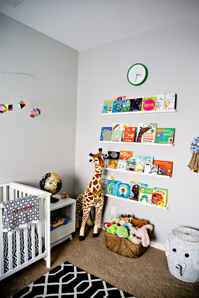 Photo of a mid-sized modern nursery for boys in Dallas with grey walls and carpet.