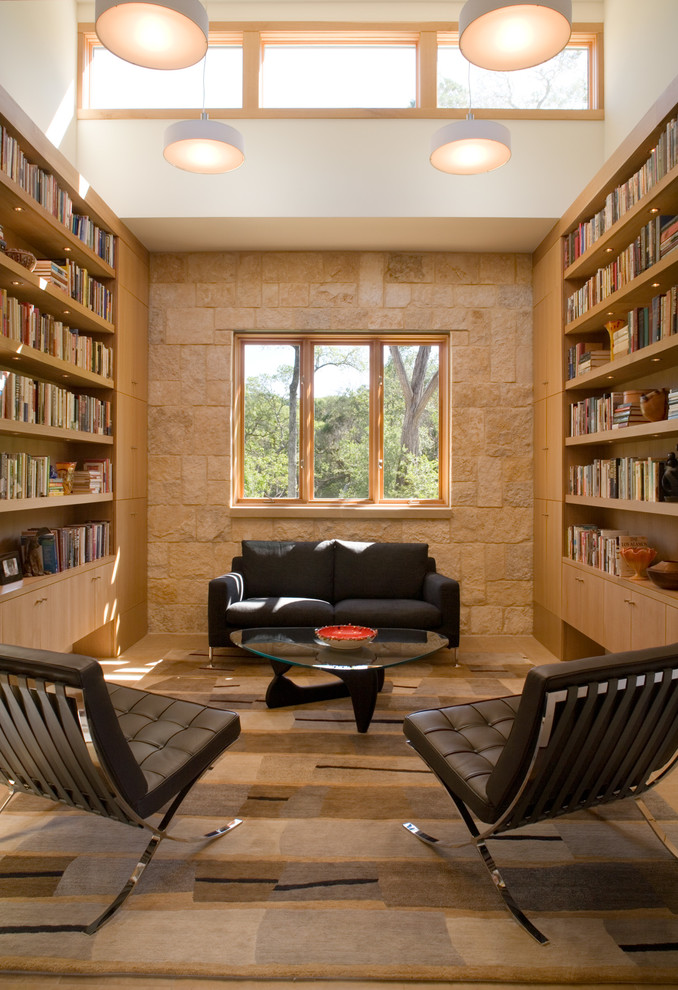 Inspiration for a contemporary family room in Austin with a library, beige walls and multi-coloured floor.