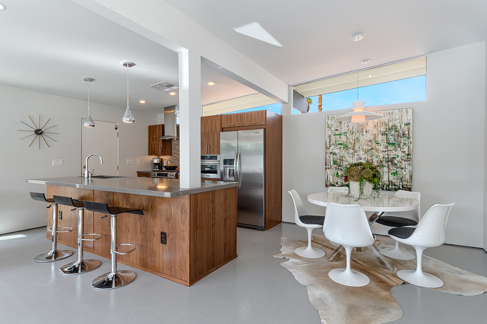 Photo of a midcentury galley eat-in kitchen in Los Angeles with an undermount sink, flat-panel cabinets, medium wood cabinets, quartzite benchtops, brown splashback and stainless steel appliances.