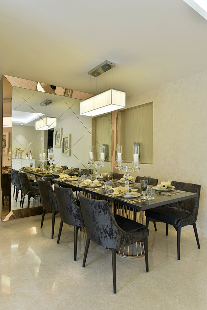 This is an example of a mid-sized contemporary kitchen/dining combo in Mumbai with marble floors.