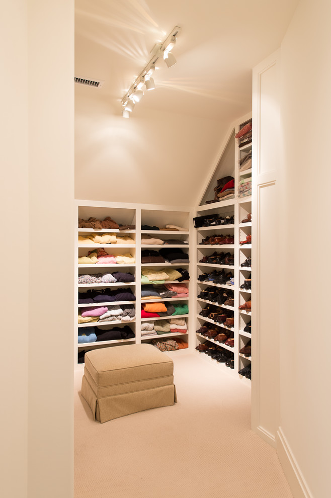 This is an example of a traditional walk-in wardrobe in Charleston.