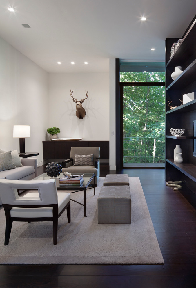 Inspiration for a large modern open concept family room in New York with white walls and dark hardwood floors.