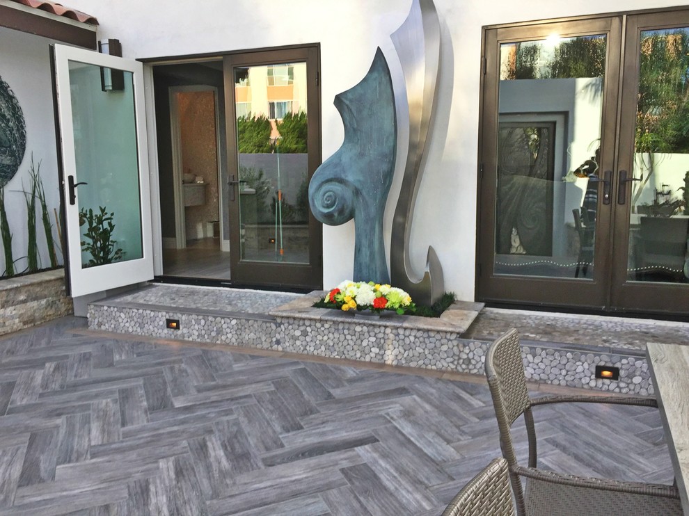 Patio - large contemporary backyard patio idea in San Diego with no cover