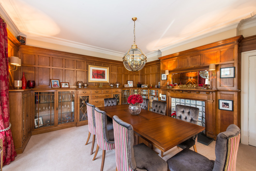 Traditional dining room in Edinburgh with carpet, a standard fireplace and a wooden fireplace surround.