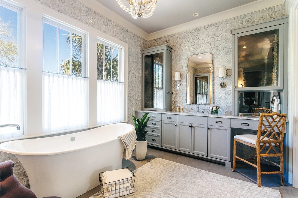 This is an example of a tropical master bathroom in Charleston with recessed-panel cabinets, grey cabinets, a freestanding tub and multi-coloured walls.