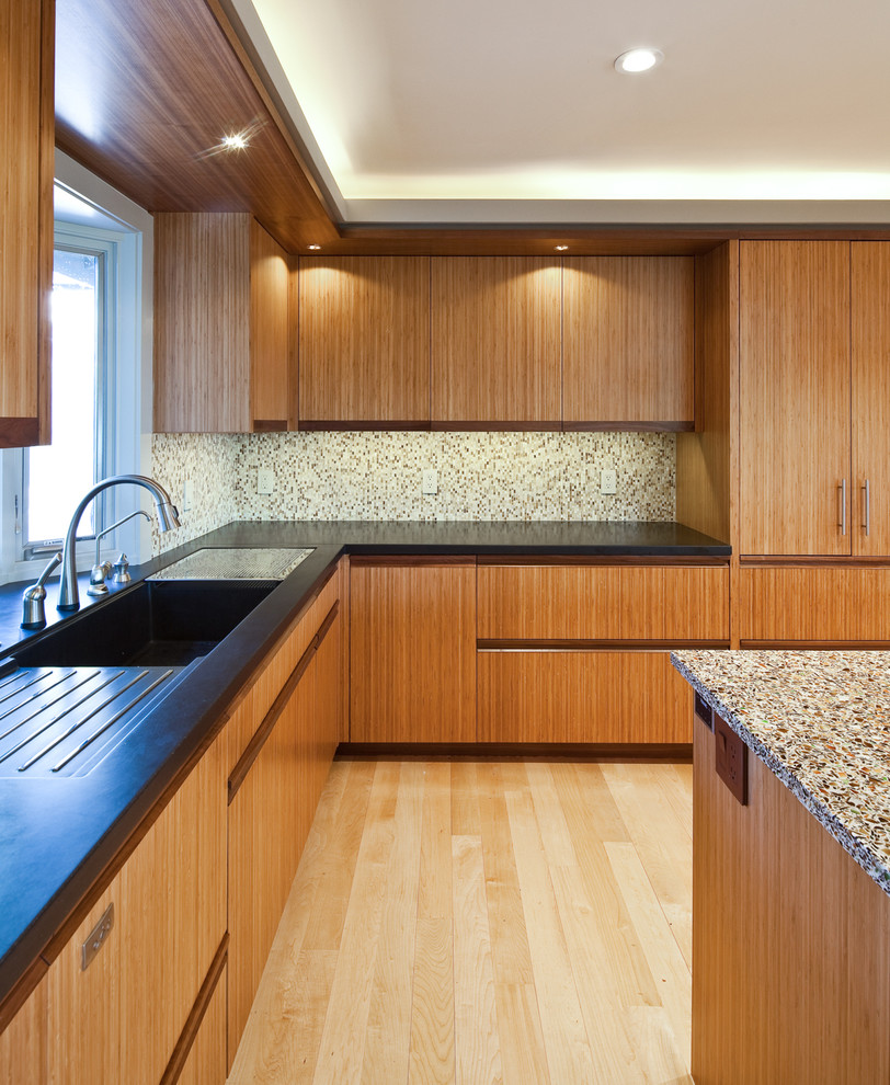This is an example of a contemporary l-shaped eat-in kitchen in San Francisco with an integrated sink, flat-panel cabinets, medium wood cabinets and multi-coloured splashback.