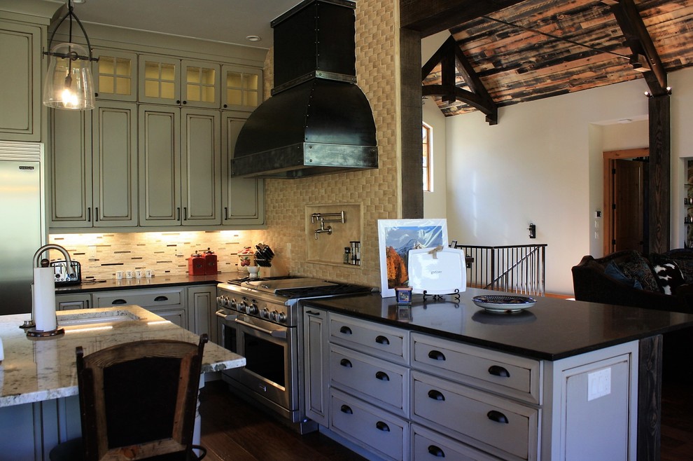 Open concept kitchen - huge rustic l-shaped open concept kitchen idea with an undermount sink, quartz countertops, beige backsplash, stone tile backsplash, stainless steel appliances and an island