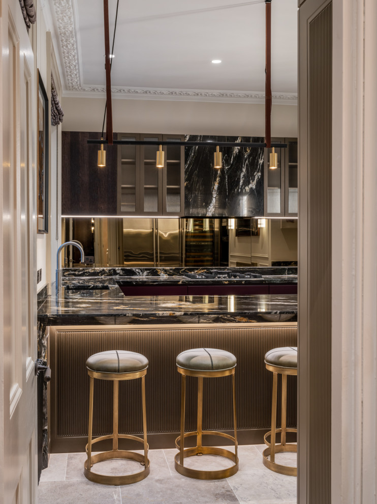 Mid-sized traditional u-shaped kitchen in London with an undermount sink, flat-panel cabinets, dark wood cabinets, marble benchtops, metallic splashback, mirror splashback, stainless steel appliances, marble floors, with island, beige floor and black benchtop.