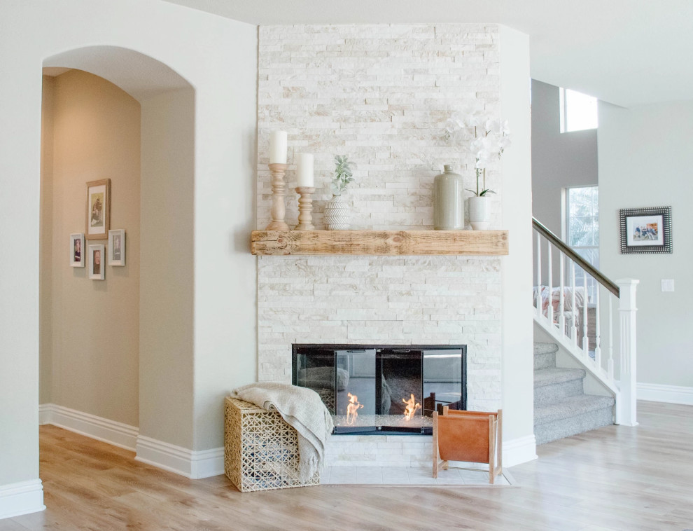 Inspiration for a small transitional open concept family room in San Diego with grey walls, vinyl floors, a standard fireplace, a stone fireplace surround and beige floor.