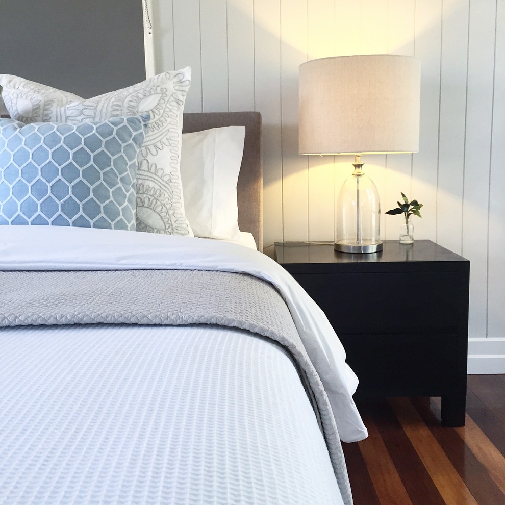 This is an example of a mid-sized transitional master bedroom in Brisbane with grey walls and medium hardwood floors.
