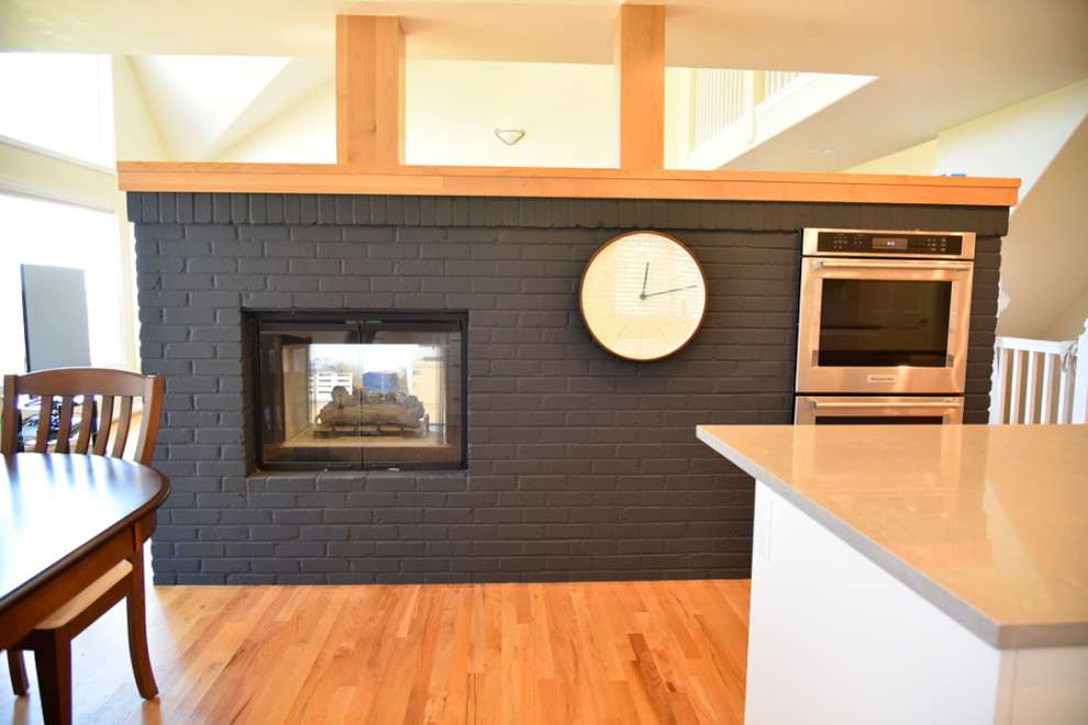Mid-sized transitional single-wall porcelain tile, beige floor and coffered ceiling eat-in kitchen photo in Denver with an undermount sink, shaker cabinets, beige cabinets, quartz countertops, beige backsplash, cement tile backsplash, stainless steel appliances, an island and beige countertops