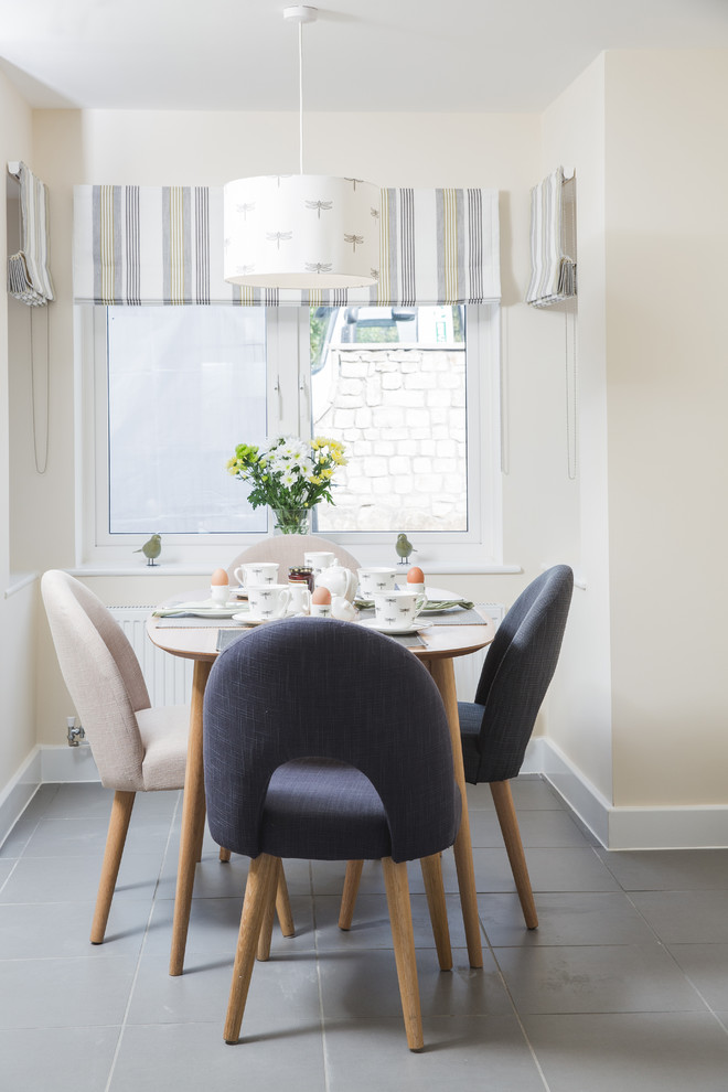 Photo of a small scandinavian dining room in Gloucestershire with beige walls and grey floor.