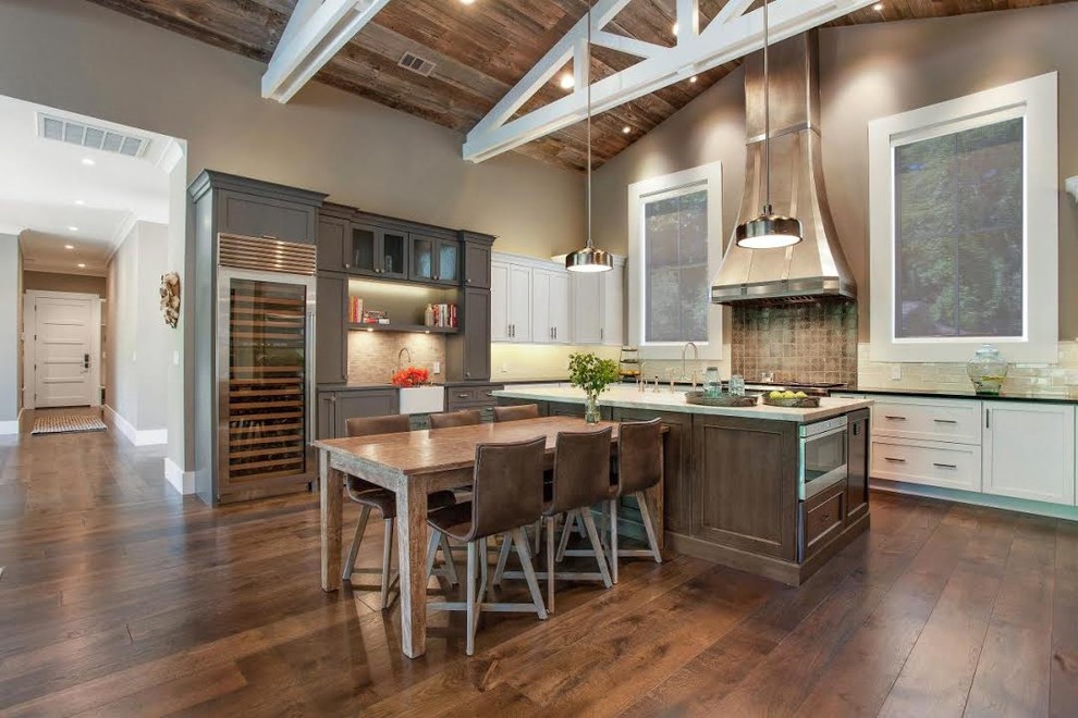 Inspiration for a large contemporary l-shaped medium tone wood floor open concept kitchen remodel with recessed-panel cabinets, white cabinets, solid surface countertops, white backsplash, subway tile backsplash, stainless steel appliances and an island