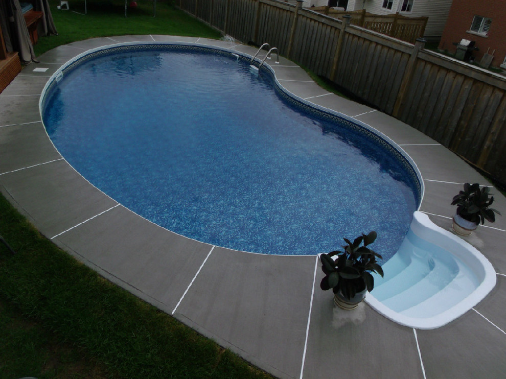 Example of a transitional backyard concrete and round pool design in Toronto