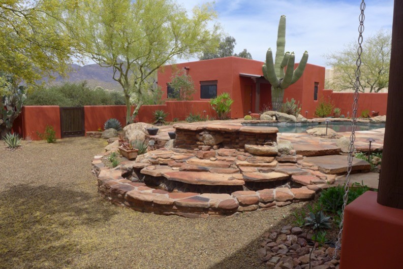 This is an example of a small backyard patio in Phoenix with stamped concrete and no cover.