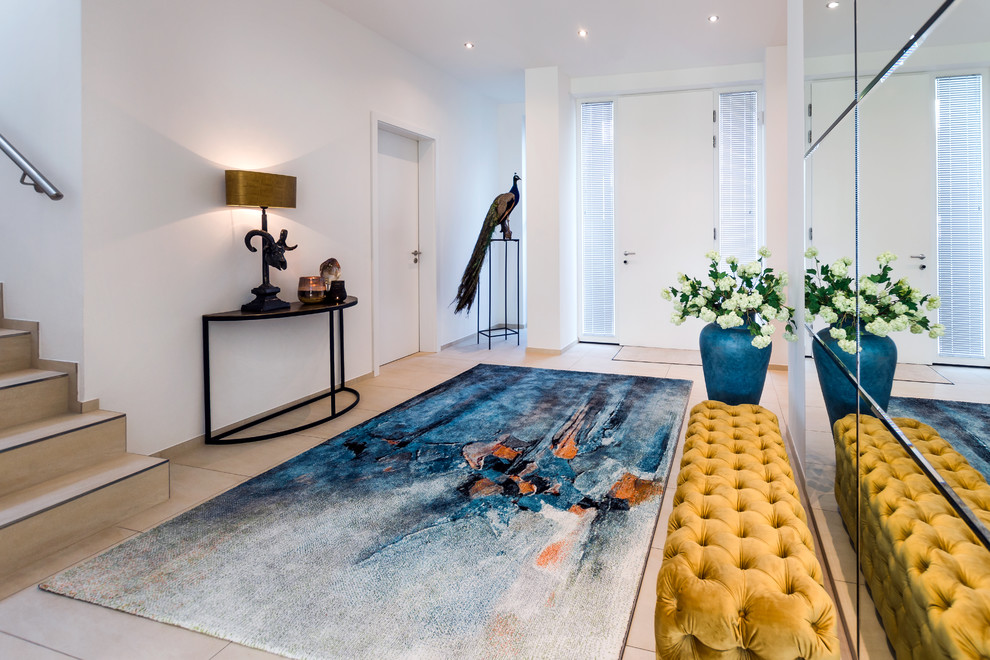 Photo of an expansive contemporary vestibule in Other with white walls, ceramic floors, a single front door, a white front door and beige floor.