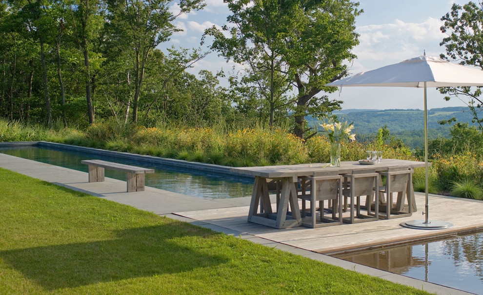 Inspiration for a country backyard pool in New York with decking.