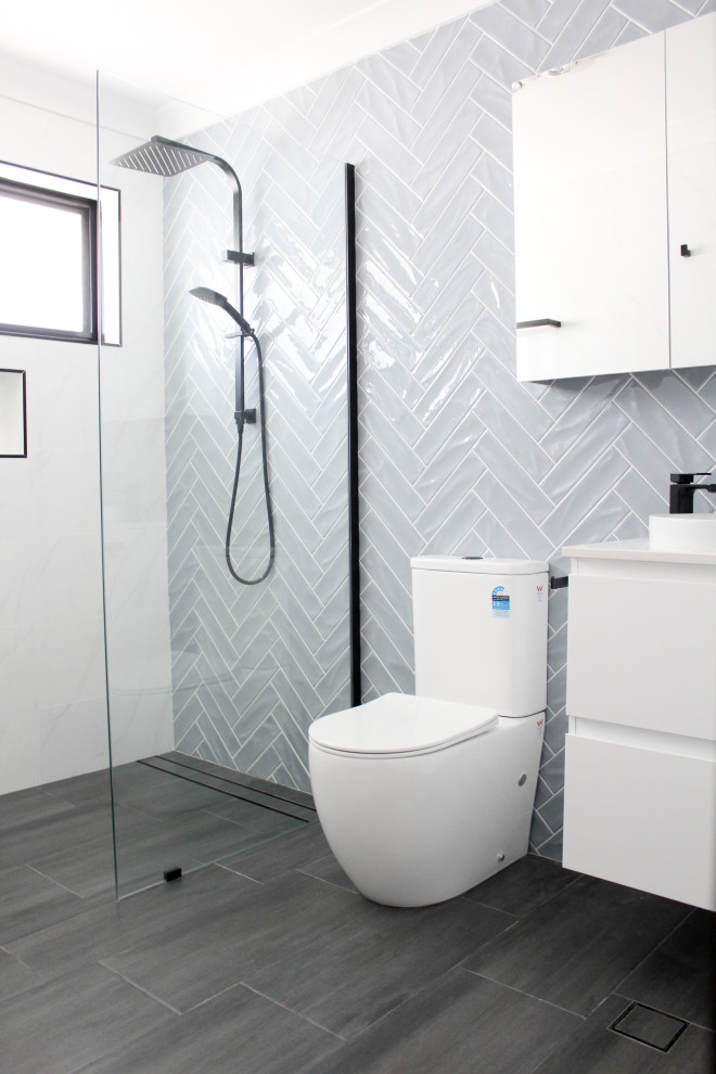 Design ideas for a mid-sized modern 3/4 bathroom in Perth with flat-panel cabinets, white cabinets, an open shower, a one-piece toilet, blue walls, porcelain floors, a vessel sink, copper benchtops, black floor, an open shower, white benchtops, a single vanity and a floating vanity.