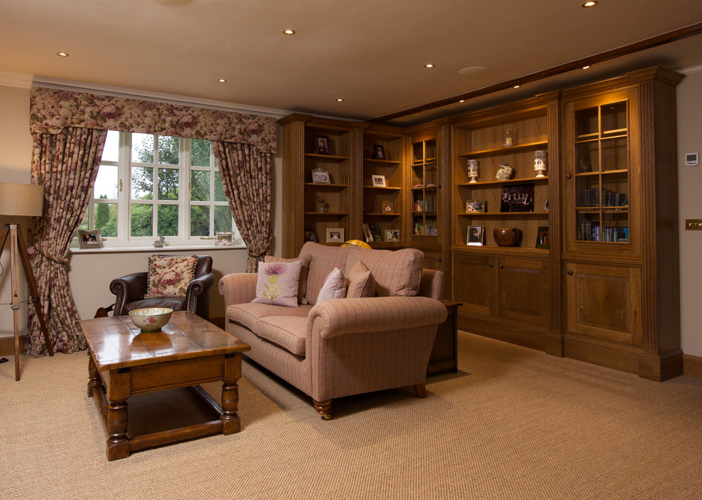 This is an example of a large country open concept living room in Other with a library, beige walls, carpet and no tv.
