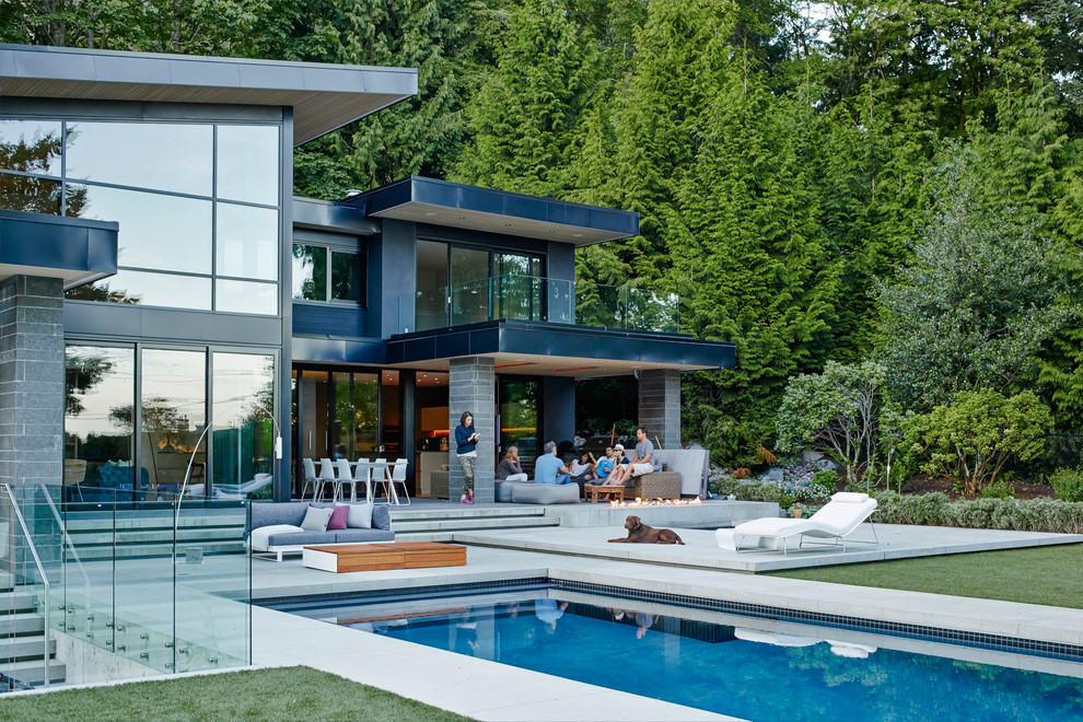 Design ideas for a large contemporary two-storey glass exterior in Vancouver with a shed roof.