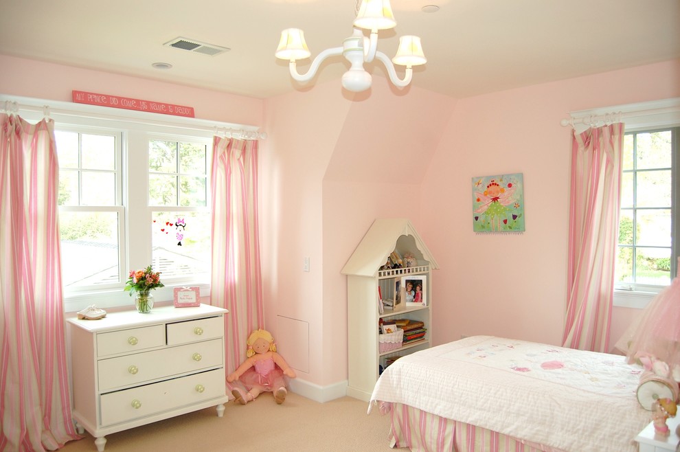 This is an example of a mid-sized traditional kids' bedroom for kids 4-10 years old and girls in San Francisco with pink walls, carpet and beige floor.