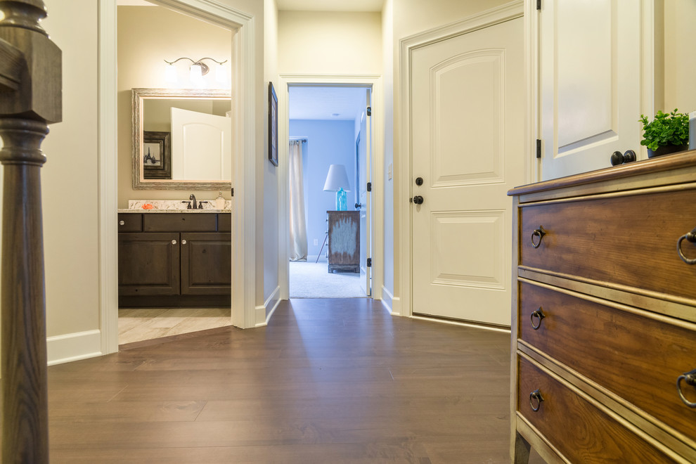 This is an example of a mid-sized beach style hallway with dark hardwood floors, brown floor and beige walls.