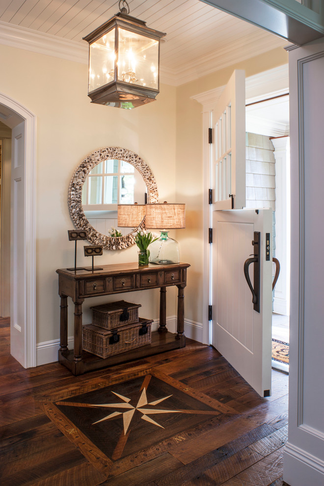 Photo of a beach style foyer in Los Angeles with beige walls, dark hardwood floors, a dutch front door and a white front door.