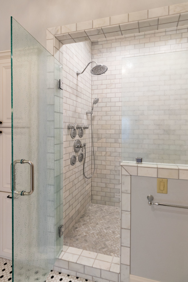 Photo of a mid-sized traditional master bathroom in Other with raised-panel cabinets, white cabinets, engineered quartz benchtops, grey benchtops, a drop-in tub, an alcove shower, gray tile, subway tile, multi-coloured walls, mosaic tile floors, an undermount sink, white floor and a hinged shower door.
