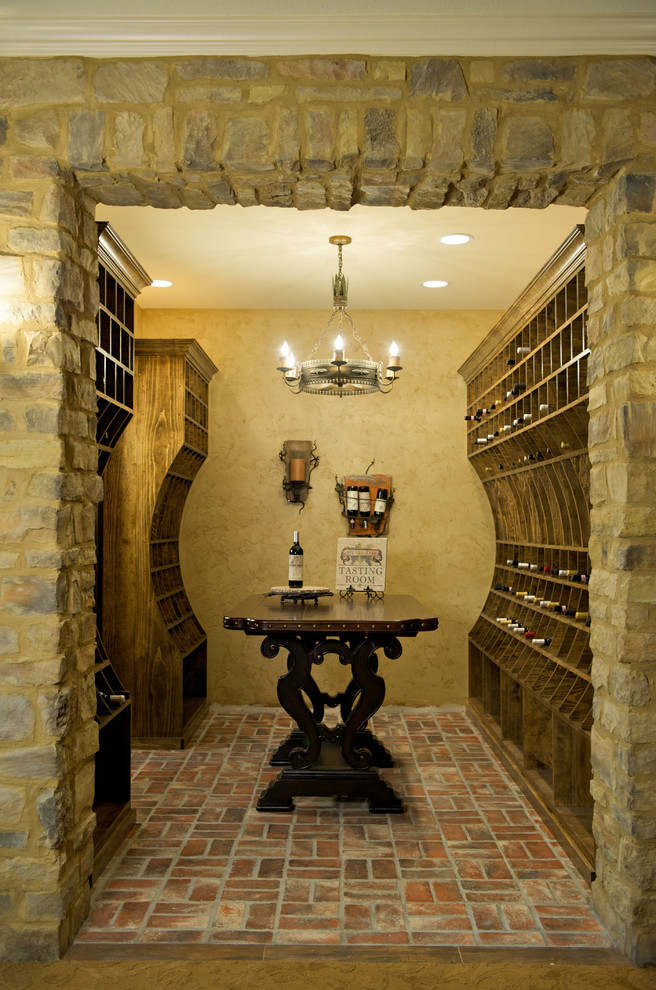Design ideas for a traditional wine cellar in Kansas City with brick floors and storage racks.