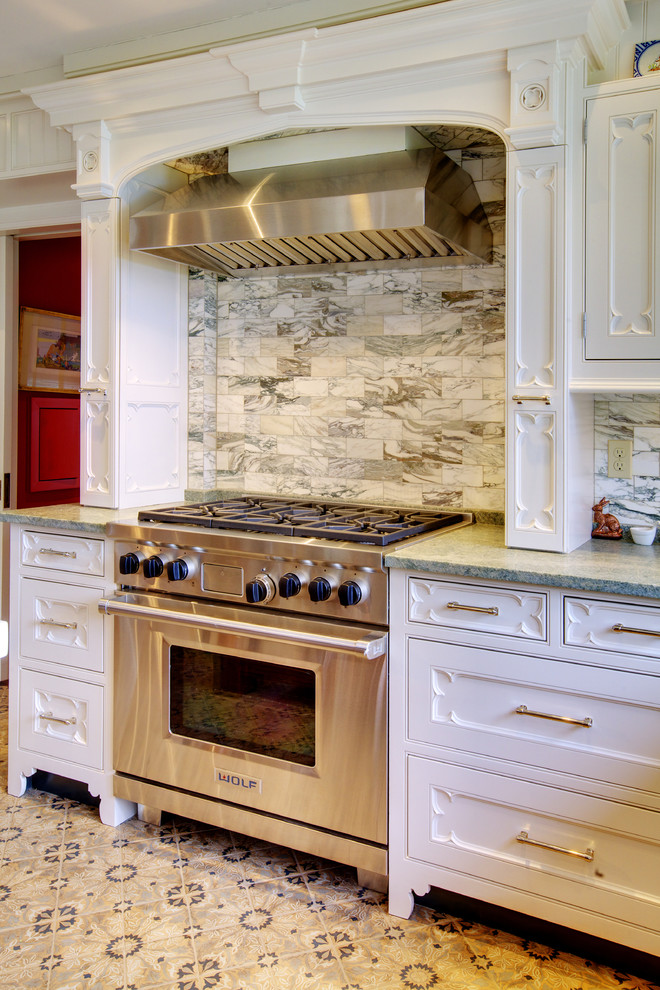 Example of a mid-sized transitional single-wall ceramic tile eat-in kitchen design in Seattle with stone tile backsplash and multicolored backsplash