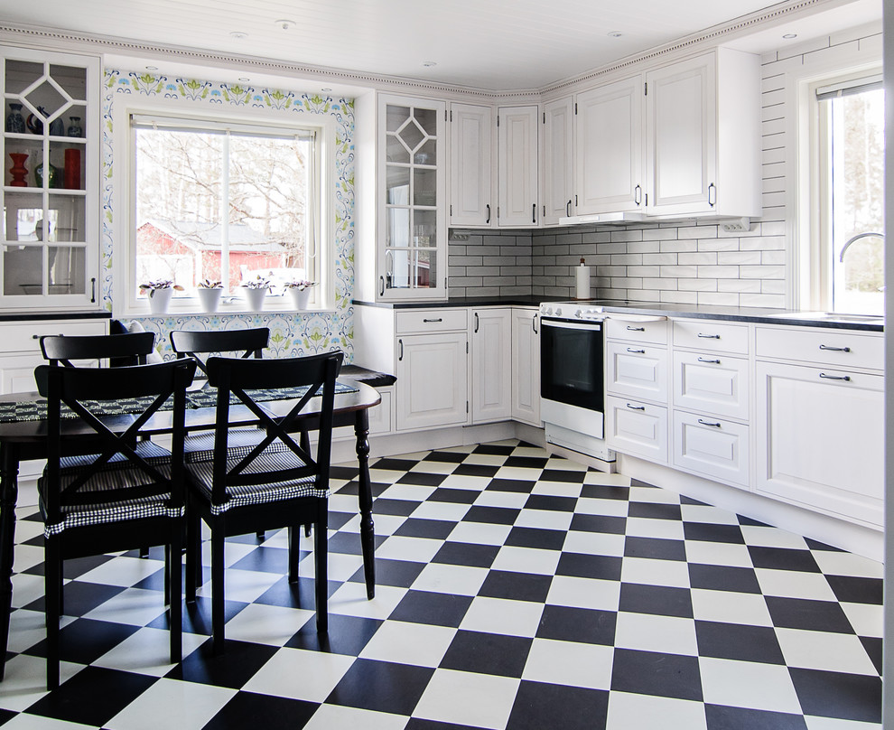 This is an example of a mid-sized traditional kitchen in Other with recessed-panel cabinets, white cabinets, grey splashback, subway tile splashback, white appliances and ceramic floors.