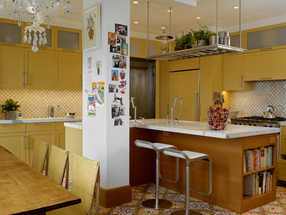 This is an example of a contemporary galley eat-in kitchen in New York with yellow cabinets, yellow splashback, panelled appliances and shaker cabinets.