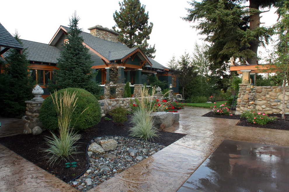 This is an example of a large traditional front yard garden in Seattle with natural stone pavers.