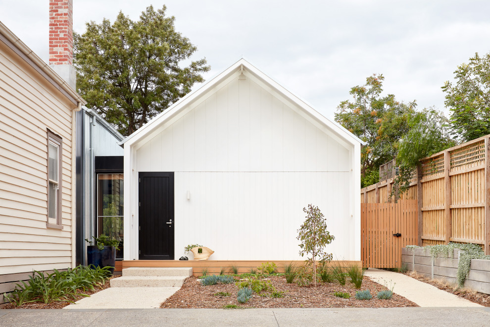 Photo of a large contemporary one-storey white house exterior in Melbourne with mixed siding and a gable roof.