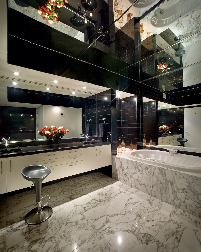 Photo of a contemporary bathroom in New York with an undermount sink and a drop-in tub.